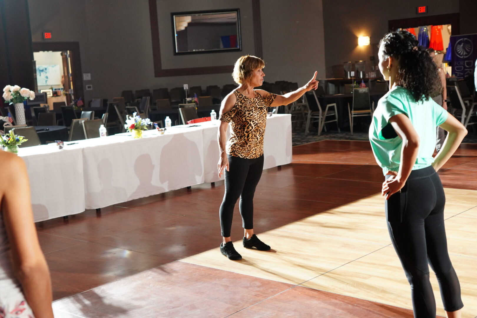 Two women are dancing on a dance floor.