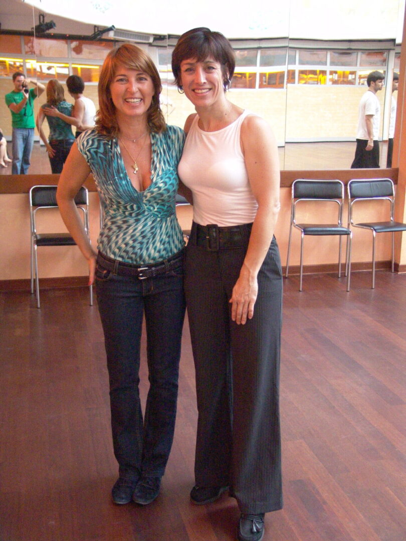 Two women standing next to each other in a room.